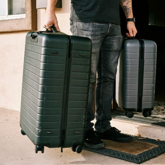 A man holding two suitcases