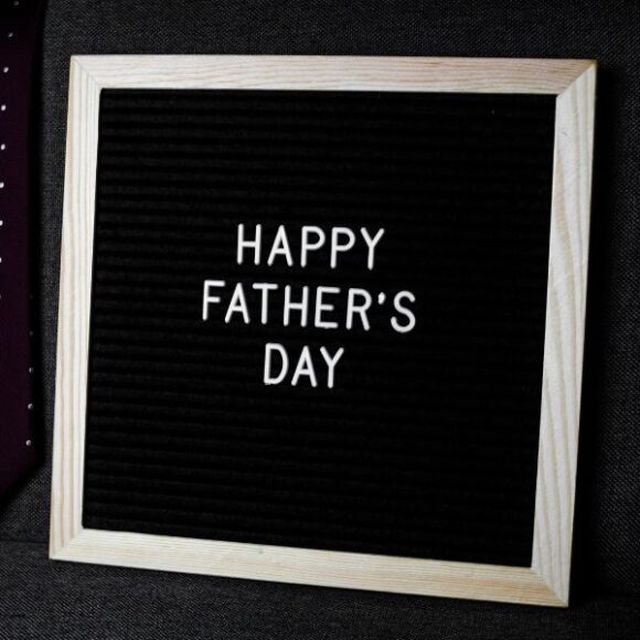 fathers_day_600x600 A frame with white letters inside spelling out Happy Father's Day on a black background