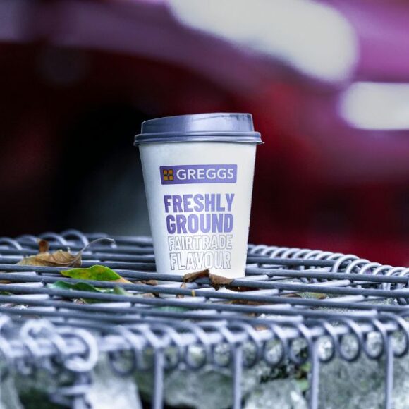 A Greggs coffee cup on a railing