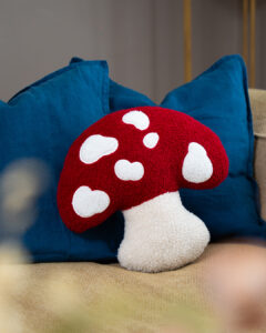 A red and white toadstool cushion