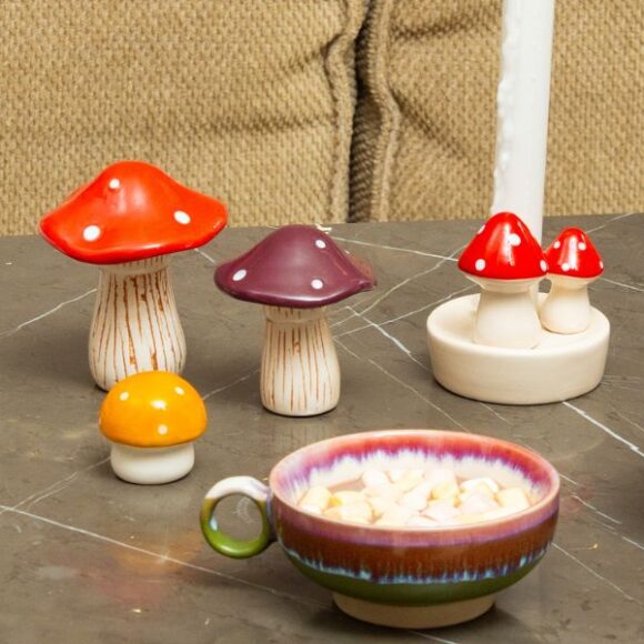 A range of toadstool ornaments and a purple bowl full of popcorn